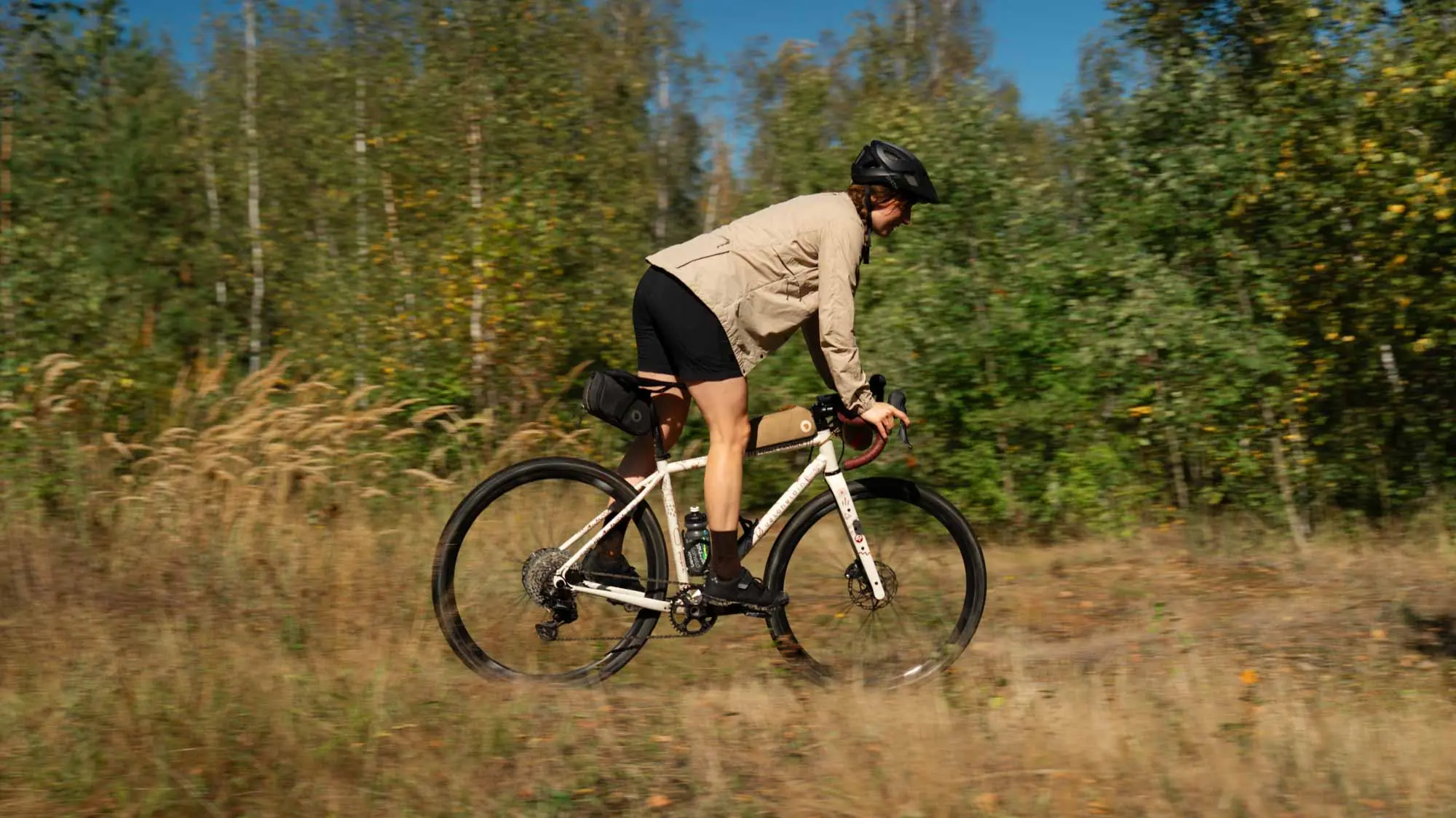 A woman in action on her bike, cycling through the woods
