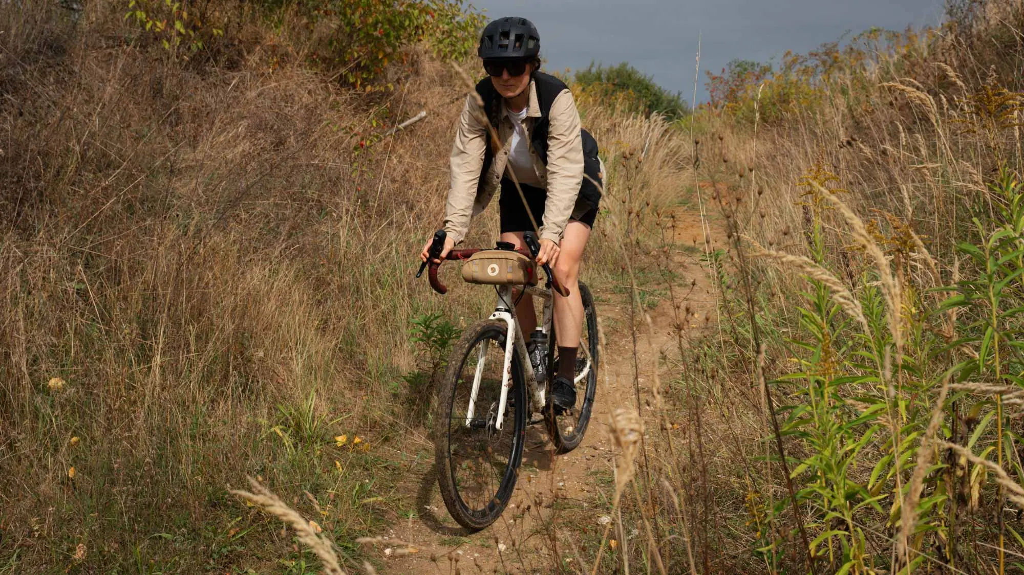 A woman rides on the gravel bike from veloheld a short slope down