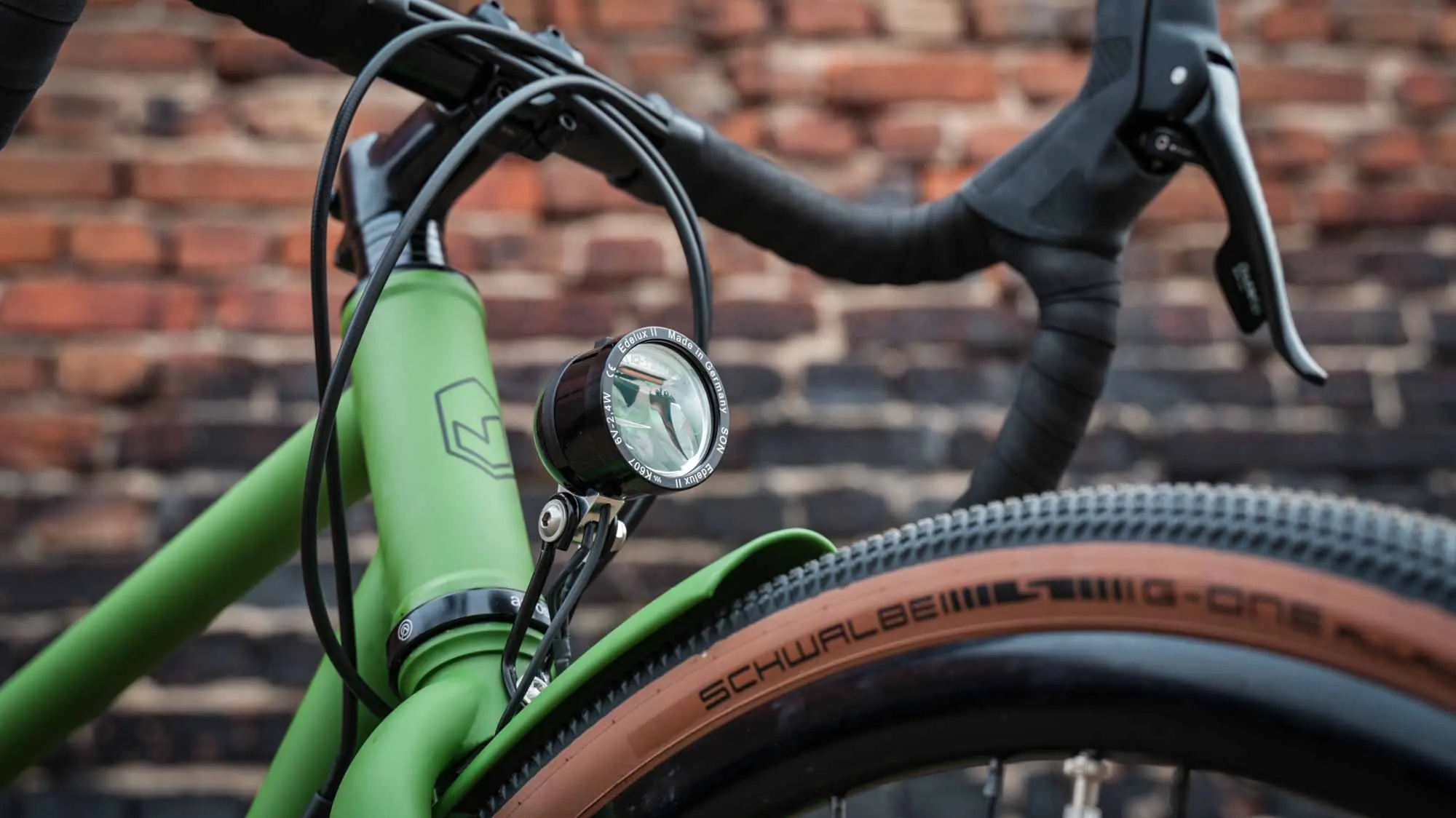 veloheld.alleyX Tourist in grass green, cockpit with SON front light in front of brick wall