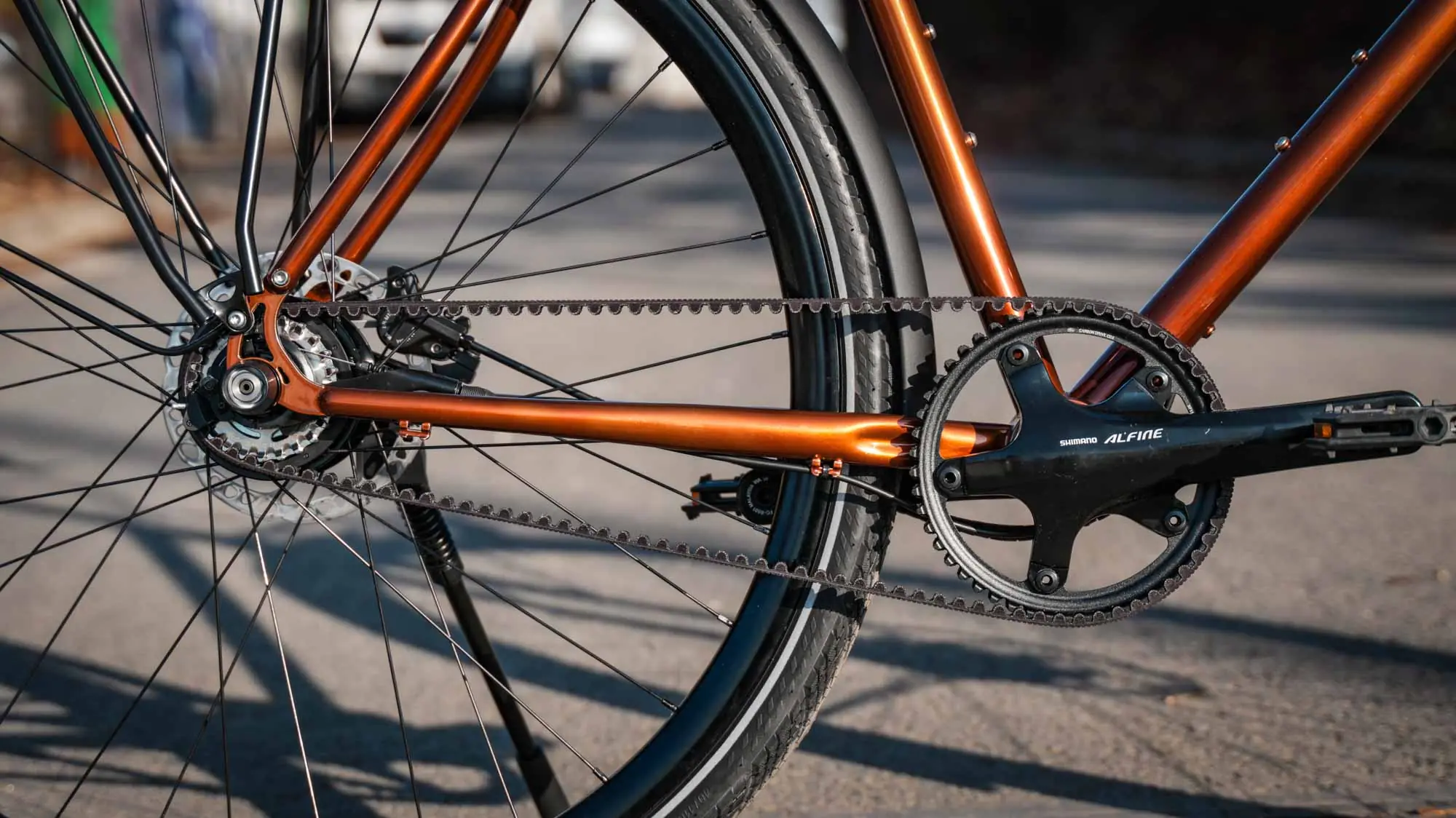 Rear wheel detail of the veloheld lane urban bike in transparent copper with belt drive and hub gears