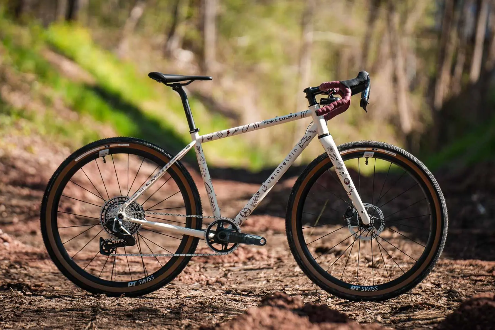 veloheld iconX Female Explorer gravel bike in the woods, custom bike for bikepacking